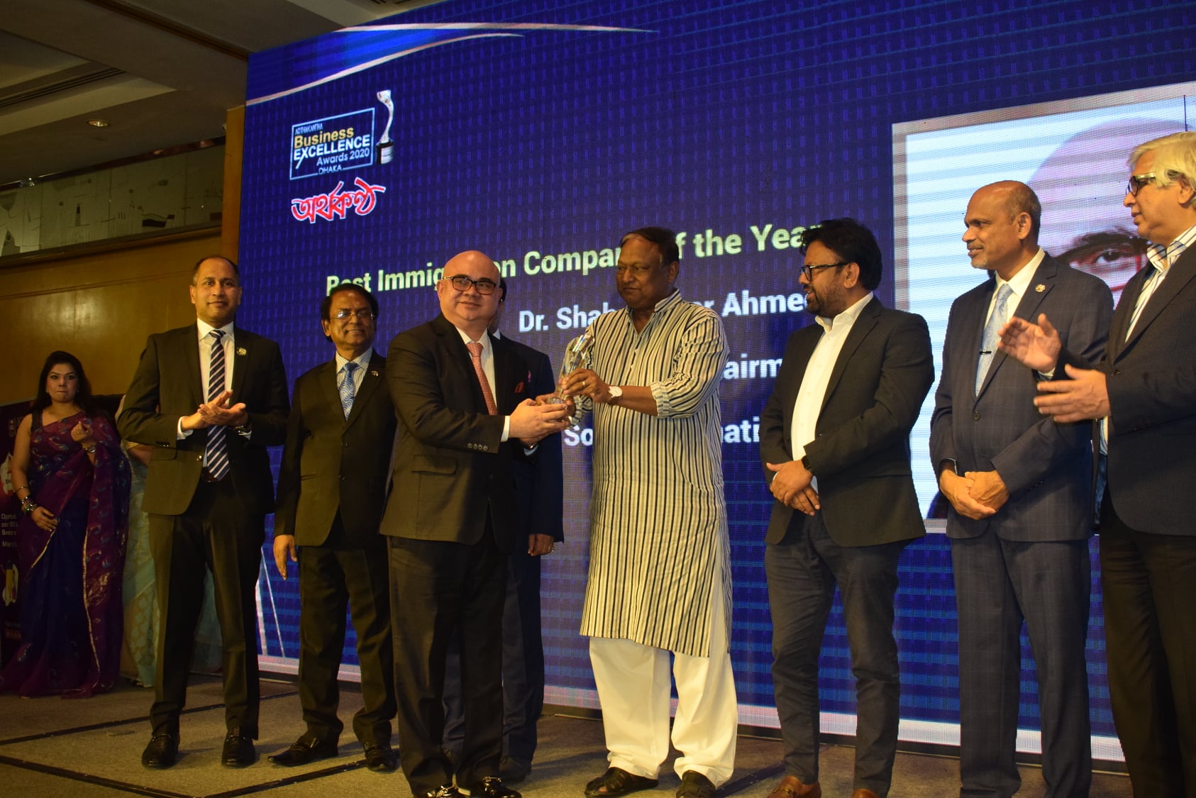 Dr. Shah Jaheer Ahmed, Chairman, Shah & Associates; “Southeast International“, receiving the Arthakantha Business Excellence Award in the ''Best Immigration Company of the Year'' Category from Honorable Commerce Minister Mr. Tipu Munshi at Westin Dhaka on December 20, 2021.